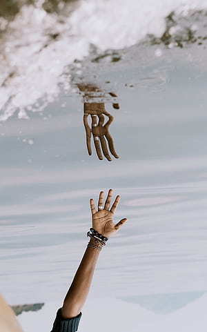 Person's hand reaching on water with reflection , phone, HD phone wallpaper